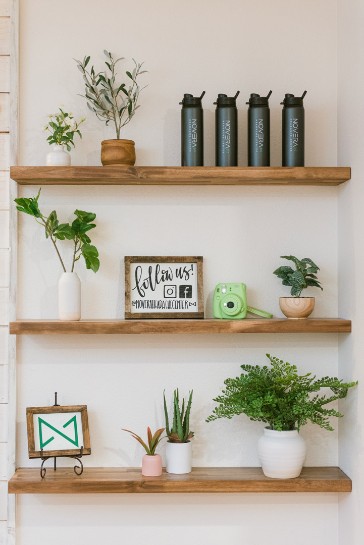 wooden floating shelves with plants at Novera Headache Center