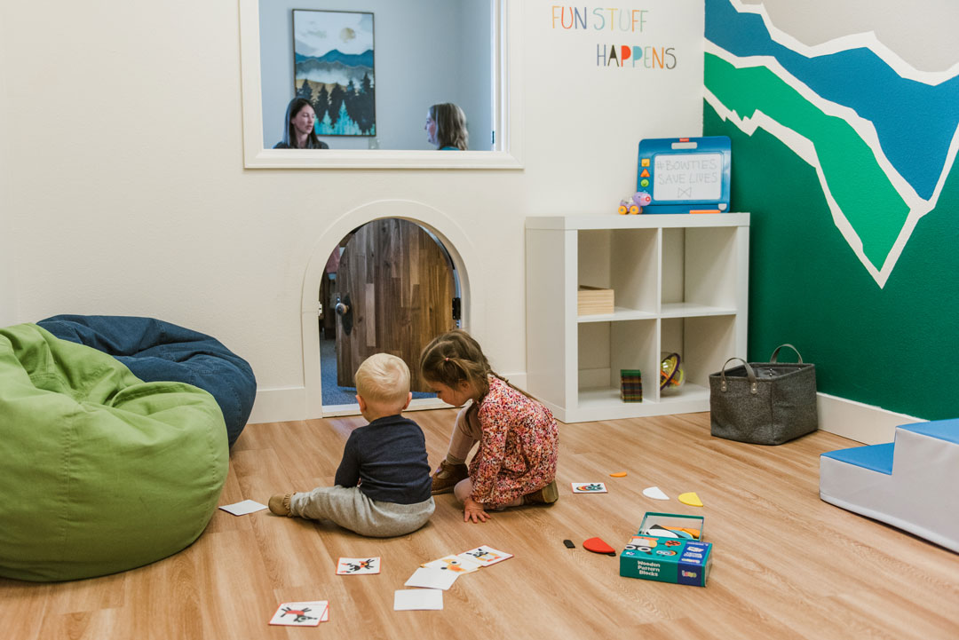 two children playing in physical therapy office playroom